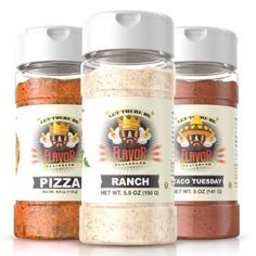 three bottles of flavored seasoning sitting next to each other