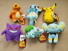 several pokemon stuffed animals are arranged in a circle