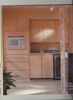 a kitchen with wood paneling and an air conditioner on the wall next to it