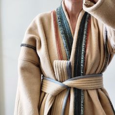 "This one of a kind wool robe, wrap coat is made from fabric remnants sourced from a U.S. heritage woolen mill. The body features a muted pink napped wool accented with graphite blanket stitch, marled moss panel down the center back, marled racing green shawl collar, and dove grey binding on the quilted belt. The belt is detachable if the wearer would prefer to style as a duster coat, body is unlined with no stretch, side seam pockets in marled forest green wool.  Body is approximately 32\" wide/across from shoulder seam down to hem.  Sleeves are approximately 16\" long from shoulder seam to cuff. Suggested to fit a size women's M to L. *Wearer in photo is 5'2\" and typically wears a size small in outerwear." Vintage Wool Blanket Coat, Moss Panel, Wool Robe, Wool Duster, Wool Blanket Coat, Quilted Robe, Green Shawl, Vintage Wool Blanket, Blanket Coat