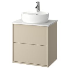 a white sink sitting on top of a wooden cabinet next to a faucet