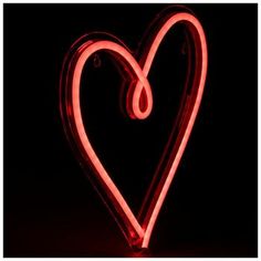 a heart shaped neon sign in the dark