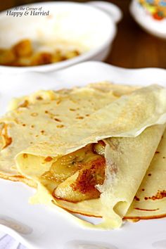 three quesadillas on a white plate with other dishes in the back ground