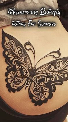 the back of a woman's stomach with an intricate butterfly tattoo on her side