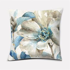 a white and blue flower pillow on a white background