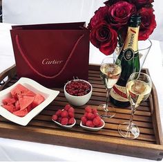 a valentine's day card with roses, raspberries and champagne on a tray