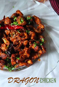 a glass bowl filled with fried food on top of a white cloth covered tablecloth