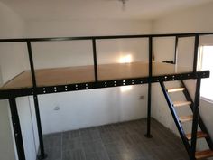 a loft bed with stairs in an empty room