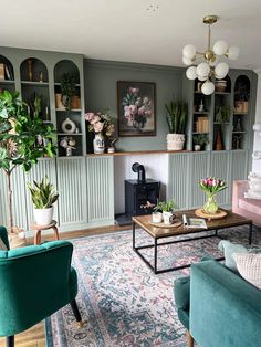 a living room filled with furniture and lots of plants on the shelves above it's fireplace