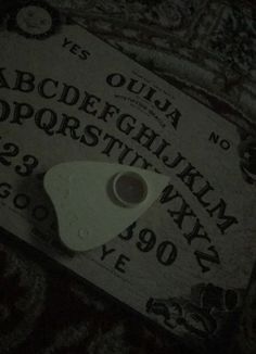 a close up of a paper with letters and numbers on it in the night time