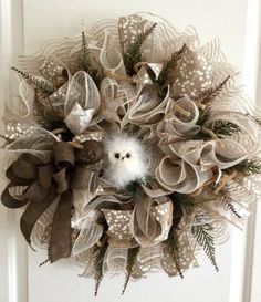 a wreath with an owl sitting on top of it