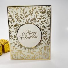 a white and gold christmas card next to some candy