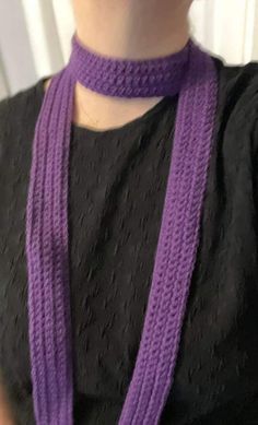 a woman wearing a purple scarf around her neck