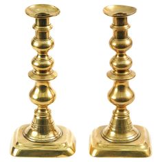 pair of brass candlesticks on white background