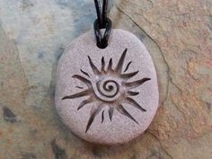 a stone with a sun design on it