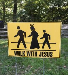 a walk with jesus sign in the grass next to a fence and some trees behind it