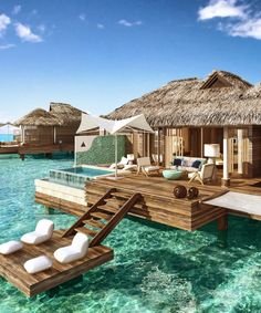 an over water resort with thatched huts and lounges on stilts in the ocean