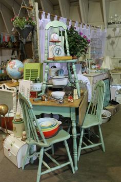 an assortment of furniture and decor items on display in a room with lots of hanging decorations