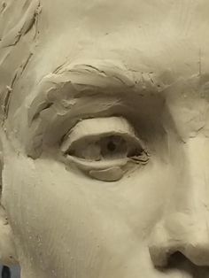 a close up of a clay statue of a man's face