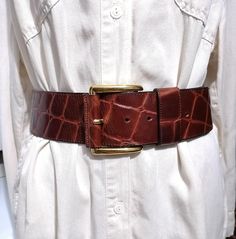 Vintage Luxurious Extra Wide Brown leather Belt , large square gold-toned buckle belt, crocodile-embossed leather belt Elegant Waist Belt  The belt is in very good condition, no signs of wear and use Wide: 6 cm/ 2.2 in Lenght: 100 cm / 40 in Fit to waist: 81-90 cm/ 32- 35 in (with the option to add extra holes for a smaller waist) Materials: leather Defects: none Condition: very good vintage condition See more like this in my shop: https://www.etsy.com/shop/VintageInsparation?ref=seller-platform-mcnav  BUY 3 ITEMS GET 15% off  Be welcome to visit my other Etsy shop for handmade upcycled clothes and bags: https://www.etsy.com/shop/ArtAnnByBoutique?ref=profile_header Leather Waist Belt, Smaller Waist, Upcycled Clothes, Profile Header, Brown Leather Belt, Suspender Belt, Buckle Belt, Small Waist, Upcycle Clothes