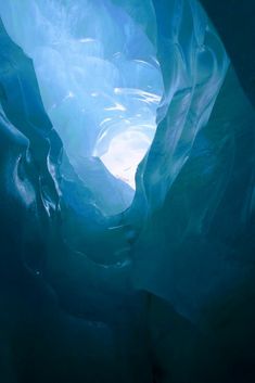 the inside of an ice cave with light coming through