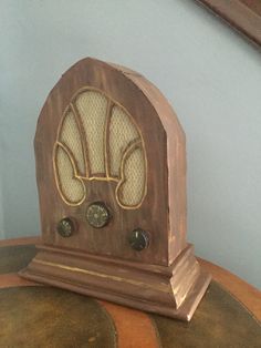 an old wooden radio sitting on top of a table