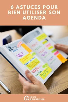 a person is holding an open book with sticky notes on it and the words, 6 astuces pour bien utiler son agenda