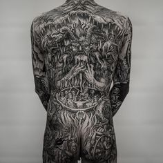 the back of a man with tattoos on his body