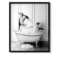 two penguins are jumping into a bathtub