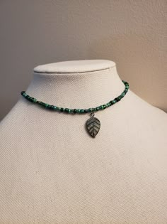 A beaded choker made of various shades of green glass beads and a glass leaf charm that has a bronze tone.  The beaded part of necklace is 14in and has a 2in extending chain. The beads are do not follow a specific pattern so they will vary with each necklace. Green Czech Glass Beaded Necklace With Dangling Beads, Earthy Jewelry, Beaded Leaf, Saint Michael, Hippie Necklace, Funky Jewelry, Jewelry Lookbook, Forest Fairy, Themed Jewelry