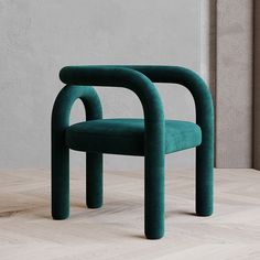 two green chairs sitting next to each other on a wooden floor in front of a wall