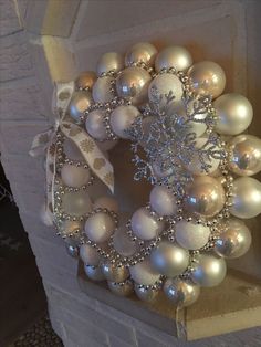 a wreath made out of white and silver ornaments