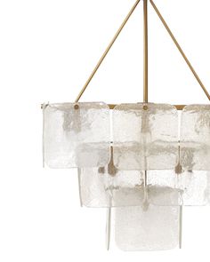 a chandelier made out of glass blocks hanging from a brass frame and metal rod