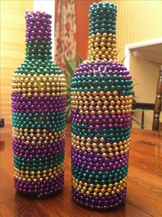 two vases made out of beads sit on a table