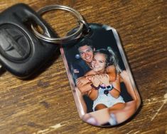 a keychain with an image of a man and woman holding each other on it