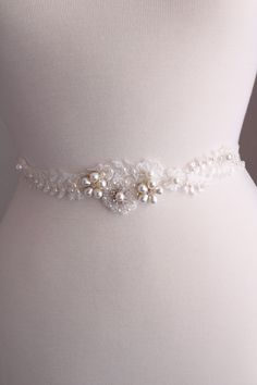 Floral Bridal Belt, Wedding Belt, Wedding Sash,  Wedding Belt,Ivory  Sash, Floral belt, Dress Belt Bridal Sash Belt , Wedding Belt ,  wedding belt - KIM * 100% Handmade in United Kingdom*  WEDDING SASH BELT DETAILS Bridal sash, perfect for vintage inspired or one very romantic   wedding.  Lace accent size approx 12 inches, width 2-4.5 cm. Sash colour: light ivory/ivory/silver/antique silver The elegant  ivory  lace is intricately beaded with light ivory faux pearls crystal rhinestones, seed beads, sequins,flower embellishments  give this amazing piece just the right touch of shimmer! A beautiful wedding sash that will compliment your bridal style! Satin ribbon in ivory, pale pink, dusky pink/peach or navy blue  25 mm available  ( 25mm x 260 cm), for you to tie a bow at the back . (Please N Sash Wedding Dress, Lace Belt, Floral Belt, Bridal Sash Belt, Wedding Belt, Wedding Dress Belt, Wedding Sash Belt, Dress Sash, Wedding Sash