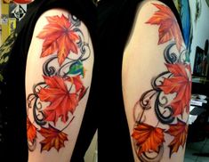 a woman's arm with an orange and red leaf tattoo design on her left arm