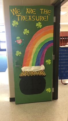 a st patrick's day door decoration with a pot of gold and a rainbow