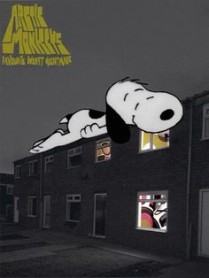 a snoopy dog hanging from the side of a building