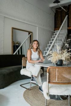 a woman sitting at a table in a living room