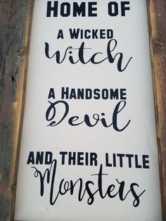 a sign that says, home of a witch and a handsome devil and their little monsters