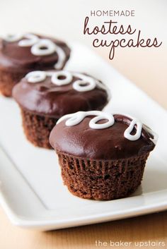 three chocolate cupcakes on a white plate with the words homemade hostess cupcakes