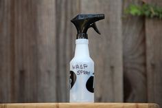 a spray bottle with the words masp story written on it sitting on top of a wooden table