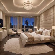 a large bed sitting in a bedroom under a chandelier next to a window