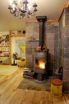 a living room filled with furniture and a fire place next to a bookshelf