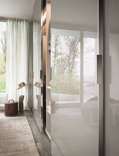 an open glass door leading to a bedroom