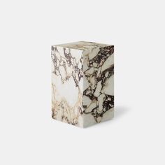 a white and black marble block sitting on top of a table