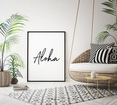 an aloha poster hanging on the wall next to a chair and potted plant