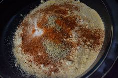 a bowl filled with spices on top of a table