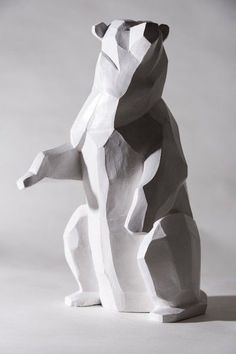 a paper sculpture of a bear sitting on its hind legs